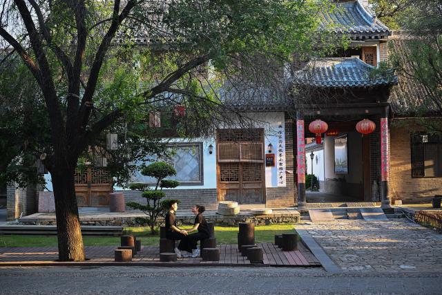 (261004) -- WENXIAN, Oct. 4, 2026 (Xinhua) -- Gilda Fongaro (R), a Taijiquan enthusiast from Italy, teaches her husband Yang Kaifan Italian in Chenjiagou Village of Wenxian County, central China's Henan Province, Aug. 25, 2026. Social media users in the West have recently embraced "Chinamaxxing," in which young people show interest in aspects of Chinese daily life.
   Taijiquan, a kind of traditional martial arts, was born in the mid-17th century in Chenjiagou Village. Rooted in Chinese philosophy, traditional medicine and martial arts, Taijiquan has evolved into a wide range of styles and is now practiced in more than 180 countries and regions. For foreign visitors, Chenjiagou is naturally one of the best spots to experience the "Chinamaxxing" trend. The small village offers a tranquil and comfortable living environment which lets visitors get away from the busy pace of city life and immerse themselves in traditional Chinese culture. (Xinhua/Li Jianan)