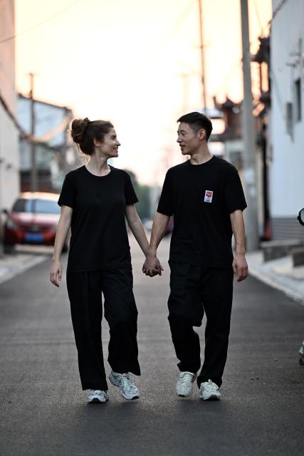 (261004) -- WENXIAN, Oct. 4, 2026 (Xinhua) -- Gilda Fongaro (L), a Taijiquan enthusiast from Italy, strolls with her husband Yang Kaifan in Chenjiagou Village of Wenxian County, central China's Henan Province, Aug. 25, 2026. Social media users in the West have recently embraced "Chinamaxxing," in which young people show interest in aspects of Chinese daily life.
   Taijiquan, a kind of traditional martial arts, was born in the mid-17th century in Chenjiagou Village. Rooted in Chinese philosophy, traditional medicine and martial arts, Taijiquan has evolved into a wide range of styles and is now practiced in more than 180 countries and regions. For foreign visitors, Chenjiagou is naturally one of the best spots to experience the "Chinamaxxing" trend. The small village offers a tranquil and comfortable living environment which lets visitors get away from the busy pace of city life and immerse themselves in traditional Chinese culture. (Xinhua/Li Jianan)