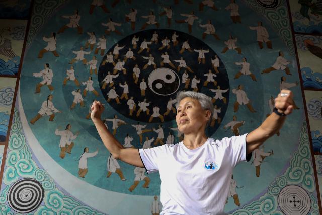 (261004) -- WENXIAN, Oct. 4, 2026 (Xinhua) -- Svetlana Kobiakova, a Russian Taijiquan coach, practices Taijiquan at a temple in Chenjiagou Village of Wenxian County, central China's Henan Province, May 19, 2026. Social media users in the West have recently embraced "Chinamaxxing," in which young people show interest in aspects of Chinese daily life.
   Taijiquan, a kind of traditional martial arts, was born in the mid-17th century in Chenjiagou Village. Rooted in Chinese philosophy, traditional medicine and martial arts, Taijiquan has evolved into a wide range of styles and is now practiced in more than 180 countries and regions. For foreign visitors, Chenjiagou is naturally one of the best spots to experience the "Chinamaxxing" trend. The small village offers a tranquil and comfortable living environment which lets visitors get away from the busy pace of city life and immerse themselves in traditional Chinese culture. (Photo by Xu Hongxing/Xinhua)