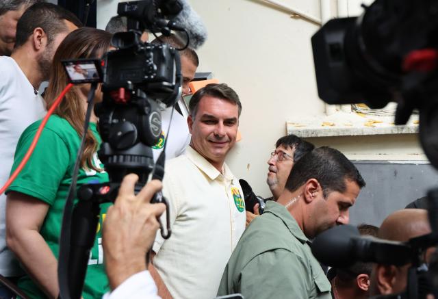 (261004) -- BRASILIA, Oct. 4, 2026 (Xinhua) -- Flavio Bolsonaro (C), presidential candidate of Brazil's Liberal Party, leaves after casting his ballot at a polling station in Rio de Janeiro, Brazil, Oct. 4, 2026. Voting in the first round of Brazil's 2026 presidential election officially began at 8 a.m. (1100 GMT) on Sunday, with polling stations across the country scheduled to close at 5 p.m. (0800 GMT).
   Initial results are expected to be announced within a few hours after the polls close. (Xinhua/Jin Haoyuan)