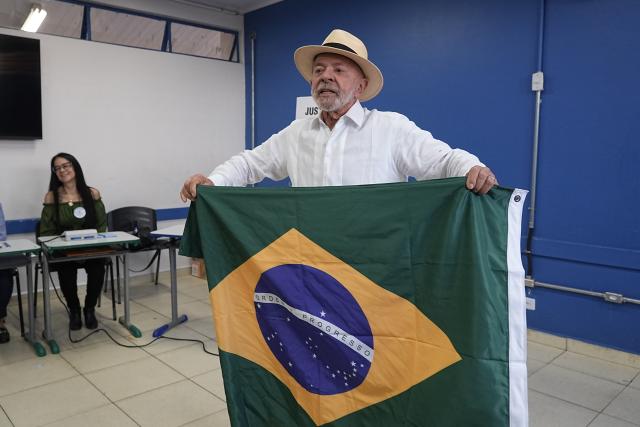 (261004) -- BRASILIA, Oct. 4, 2026 (Xinhua) -- Brazilian President Luiz Inacio Lula da Silva, presidential candidate of Brazil's ruling Workers' Party, displays a national flag of Brazil after casting his ballot at a polling station in Sao Bernardo do Campo, Brazil, Oct. 4, 2026. Voting in the first round of Brazil's 2026 presidential election officially began at 8 a.m. (1100 GMT) on Sunday, with polling stations across the country scheduled to close at 5 p.m. (0800 GMT).
   Initial results are expected to be announced within a few hours after the polls close. (Photo by Paulo Lopes/Xinhua)