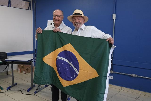 (261004) -- BRASILIA, Oct. 4, 2026 (Xinhua) -- Brazilian President Luiz Inacio Lula da Silva (R), presidential candidate of Brazil's ruling Workers' Party, displays a national flag of Brazil after casting his ballot at a polling station in Sao Bernardo do Campo, Brazil, Oct. 4, 2026. Voting in the first round of Brazil's 2026 presidential election officially began at 8 a.m. (1100 GMT) on Sunday, with polling stations across the country scheduled to close at 5 p.m. (0800 GMT).
   Initial results are expected to be announced within a few hours after the polls close. (Photo by Paulo Lopes/Xinhua)