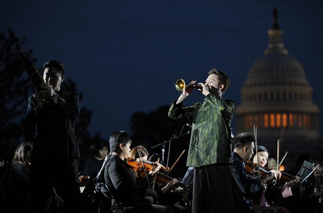 (261004) -- WASHINGTON, Oct. 4, 2026 (Xinhua) -- Chinese Suona performer Lin Wei (R, Front) and Sheng performer Jin Ziqi (L, Front) perform Music from Black Myth: Wukong -- Excerpt during "Future Resonance -- ShanghaiEye Night" in Washington, D.C., the United States, on Oct. 3, 2026. The Shanghai-themed cultural exchange event was held here on Saturday, bringing a taste of Shanghai to the United States. The event was also part of the "Shanghai Let's Meet" city promotion initiative and a broader series of China-U.S. people-to-people exchanges. (Xinhua/Li Rui)