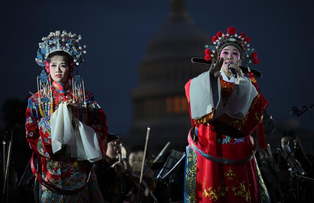 (261004) -- WASHINGTON, Oct. 4, 2026 (Xinhua) -- Chinese Huangmei Opera artists Han Zaifen (R) and Chen Bangliang perform Huangmei Opera: The Lady Consort Prince during "Future Resonance -- ShanghaiEye Night" in Washington, D.C., the United States, on Oct. 3, 2026. The Shanghai-themed cultural exchange event was held here on Saturday, bringing a taste of Shanghai to the United States. The event was also part of the "Shanghai Let's Meet" city promotion initiative and a broader series of China-U.S. people-to-people exchanges. (Xinhua/Li Rui)