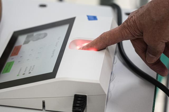 (261004) -- SAO PAULO, Oct. 4, 2026 (Xinhua) -- A voter verifies his identity at a polling station in Sao Bernardo do Campo, Sao Paulo state, Brazil, Oct. 4, 2026. Voting in the first round of Brazil's 2026 presidential election officially began at 8 a.m. (1100 GMT) on Sunday, with polling stations across the country scheduled to close at 5 p.m. (0800 GMT). Initial results are expected to be announced within a few hours after the polls close. (Photo by Paulo Lopes/Xinhua)