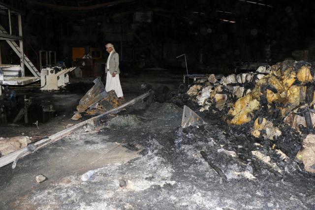 (261004) -- SANAA, Oct. 4, 2026 (Xinhua) -- A worker inspects a sponge factory after it was struck by an airstrike carried out by a Saudi warplane in Sanaa, Yemen, on Oct. 4, 2026. Yemen's Houthi group said Sunday that Saudi Arabia had launched 106 air and missile strikes across Houthi-held areas over the past 24 hours, as the internationally recognized government announced a new military campaign to retake territory from the group amid a widening escalation in the country. (Photo by Mohammed Mohammed/Xinhua)