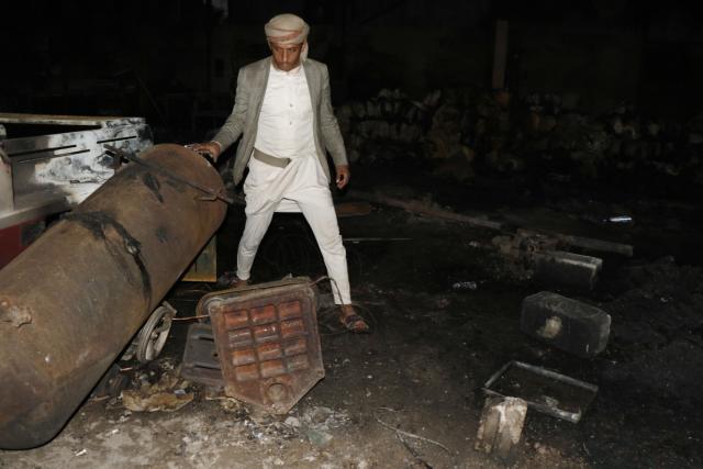 (261004) -- SANAA, Oct. 4, 2026 (Xinhua) -- A worker inspects a sponge factory after it was struck by an airstrike carried out by a Saudi warplane in Sanaa, Yemen, on Oct. 4, 2026. Yemen's Houthi group said Sunday that Saudi Arabia had launched 106 air and missile strikes across Houthi-held areas over the past 24 hours, as the internationally recognized government announced a new military campaign to retake territory from the group amid a widening escalation in the country. (Photo by Mohammed Mohammed/Xinhua)