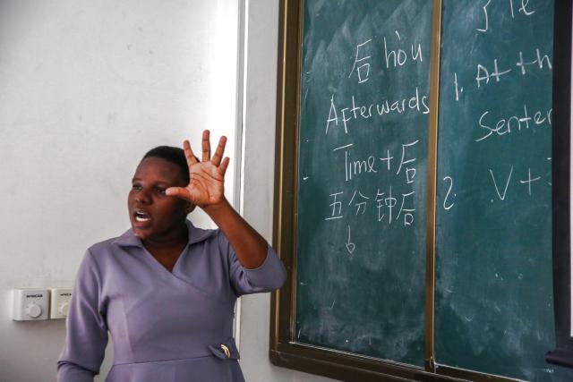 (261005) -- DAR ES SALAAM, Oct. 5, 2026 (Xinhua) -- Tanzanian Chinese language teacher Gloria Mshana explains Chinese grammar to students in front of the blackboard at the Confucius Institute at the University of Dar es Salaam in Dar es Salaam, Tanzania, Oct. 1, 2026.
  As the world prepares to mark World Teachers' Day on Oct. 5, Chinese and Tanzanian educators are joining forces to expand Chinese language education in Tanzania, blending native linguistic expertise with localized cultural insights.
   TO GO WITH "Roundup: Chinese, Tanzanian educators join forces to boost Chinese language education" (Xinhua/Emmanuel Herman)