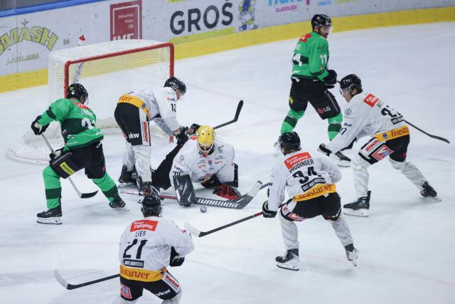 (261005) -- LJUBLJANA, Oct. 5, 2026 (Xinhua) -- Alex Caffi (C) of Pioneers Vorarlberg saves the puck during the 2026/27 ICE Hockey League match between HK Olimpija and Pioneers Vorarlberg at the Sports Hall Tivoli, Ljubljana, Slovenia, Oct 4, 2026. (Photo by Zeljko Stevanic/Xinhua)