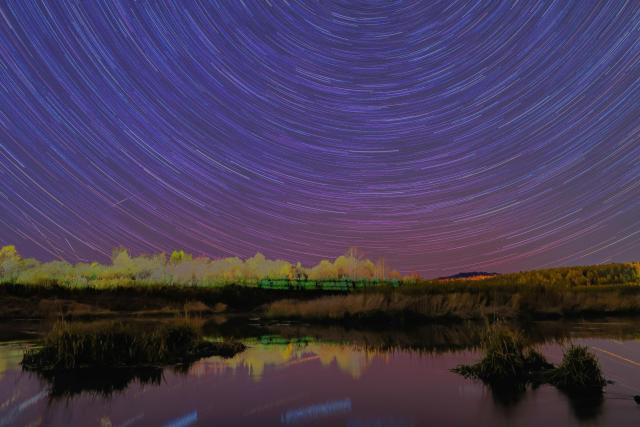 (261005) -- HARBIN, Oct. 5, 2026 (Xinhua) -- This stacked composite photo taken on Oct. 4, 2026 shows the aurora observed from Yichun City, northeast China's Heilongjiang Province. (Photo by Li Jiaxing/Xinhua)