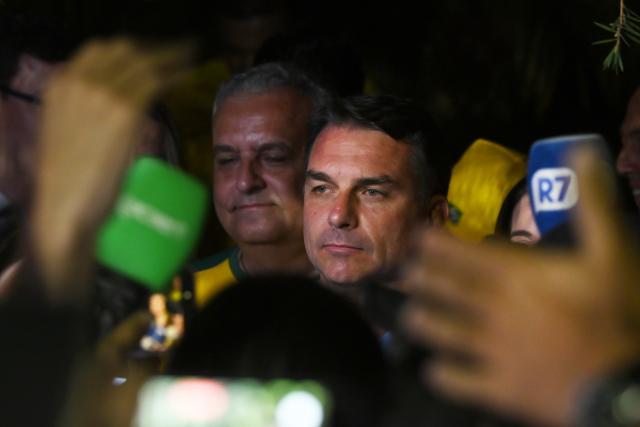 (261005) -- BRASILIA, Oct. 5, 2026 (Xinhua) -- Flavio Bolsonaro (C), presidential candidate of Brazil's Liberal Party, is seen after the announcement of the first-round results of the presidential election in Brasilia, Brazil, Oct. 4, 2026.
  Brazil will hold a presidential runoff on Oct. 25 as official results showed Sunday that no candidate secured a majority of valid votes in the first round.
  According to results released by the Superior Electoral Court, with over 99 percent of the ballots counted, Flavio Bolsonaro, presidential candidate of Brazil's Liberal Party, garnered about 47 percent of valid votes while incumbent President Luiz Inacio Lula da Silva of the Workers' Party came in second with about 45 percent.
  Under Brazil's electoral rules, a presidential candidate must secure more than half of the valid votes to win outright in the first round. Otherwise, the two candidates with the most votes advance to a runoff.
  Following the announcement of the first-round results, both candidates made remarks on Sunday night. (Xinhua/Lucio Tavora)