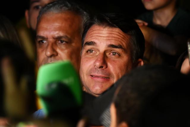 (261005) -- BRASILIA, Oct. 5, 2026 (Xinhua) -- Flavio Bolsonaro (C), presidential candidate of Brazil's Liberal Party, is seen after the announcement of the first-round results of the presidential election in Brasilia, Brazil, Oct. 4, 2026.
  Brazil will hold a presidential runoff on Oct. 25 as official results showed Sunday that no candidate secured a majority of valid votes in the first round.
  According to results released by the Superior Electoral Court, with over 99 percent of the ballots counted, Flavio Bolsonaro, presidential candidate of Brazil's Liberal Party, garnered about 47 percent of valid votes while incumbent President Luiz Inacio Lula da Silva of the Workers' Party came in second with about 45 percent.
  Under Brazil's electoral rules, a presidential candidate must secure more than half of the valid votes to win outright in the first round. Otherwise, the two candidates with the most votes advance to a runoff.
  Following the announcement of the first-round results, both candidates made remarks on Sunday night. (Xinhua/Lucio Tavora)