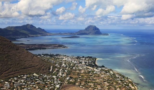 (261005) -- BLACK RIVER, Oct. 5, 2026 (Xinhua) -- An aerial photo taken on Oct. 2, 2026 shows a view of Le Morne Cultural Landscape in Black River District, Mauritius. Le Morne Cultural Landscape, a rugged mountain that juts into the Indian Ocean in the southwest of Mauritius, was inscribed on the UNESCO World Heritage List in 2008. (Xinhua/Chen Wei)
