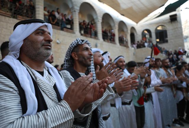 (261005) -- NABLUS, Oct. 5, 2026 (Xinhua) -- Palestinians wearing traditional attire are seen during a wedding ceremony in the West Bank city of Nablus, Oct. 3, 2026. (Photo by Ayman Nobani/Xinhua)