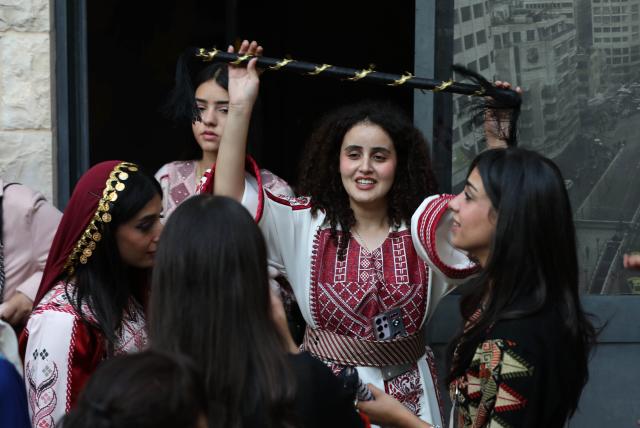 (261005) -- NABLUS, Oct. 5, 2026 (Xinhua) -- Palestinians wearing traditional attire are seen during a wedding ceremony in the West Bank city of Nablus, Oct. 3, 2026. (Photo by Ayman Nobani/Xinhua)