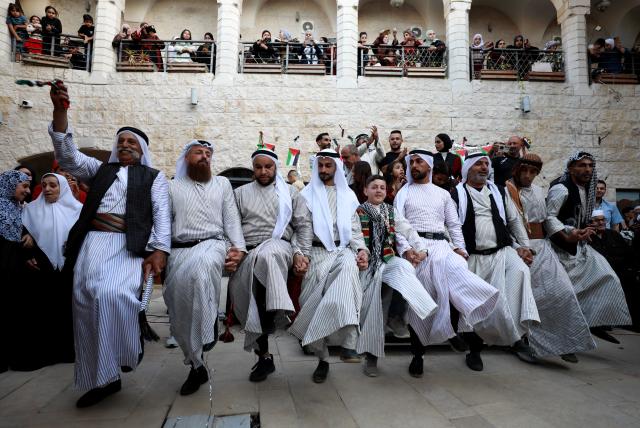 (261005) -- NABLUS, Oct. 5, 2026 (Xinhua) -- Palestinians wearing traditional attire are seen during a wedding ceremony in the West Bank city of Nablus, Oct. 3, 2026. (Photo by Ayman Nobani/Xinhua)
