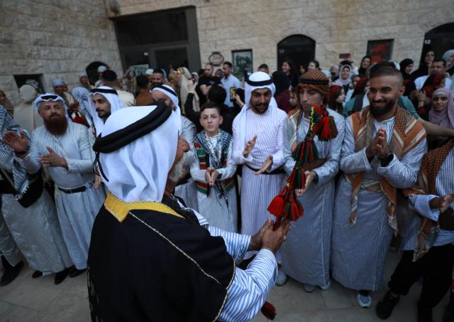 (261005) -- NABLUS, Oct. 5, 2026 (Xinhua) -- Palestinians wearing traditional attire are seen during a wedding ceremony in the West Bank city of Nablus, Oct. 3, 2026. (Photo by Ayman Nobani/Xinhua)