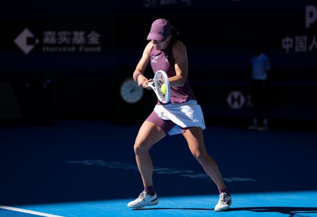 (261005) -- BEIJING, Oct. 5, 2026 (Xinhua) -- Iga Swiatek of Poland hits a return during the women's singles round of 32 match against Donna Vekic of Croatia at 2026 China Open tennis tournament in Beijing, China, Oct. 5, 2026. (Xinhua/Sun Fei)