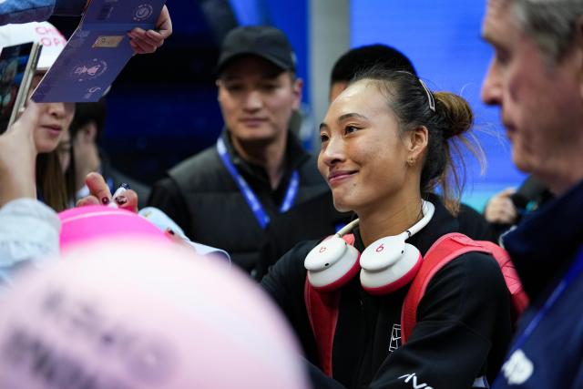 (261005) -- BEIJING, Oct. 5, 2026 (Xinhua) -- Zheng Qinwen of China signs autograph for fans after winning the women's singles round of 32 match against Marie Bouzkova of the Czech Republic at 2026 China Open tennis tournament in Beijing, China, Oct. 5, 2026. (Xinhua/Sun Fei)