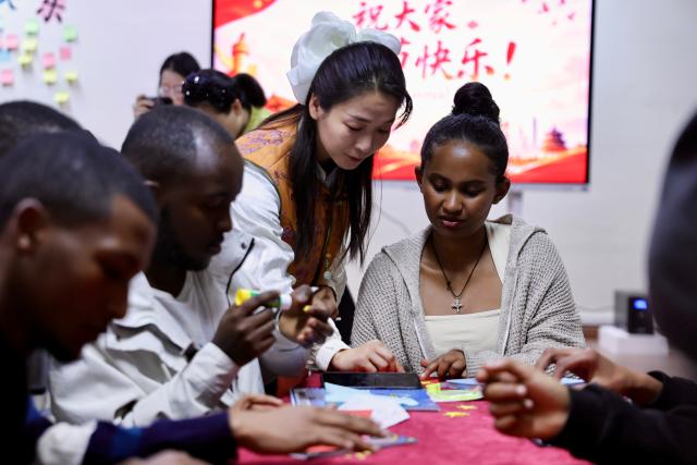 (261005) -- ADDIS ABABA, Oct. 5, 2026 (Xinhua) -- Chinese teacher Song Ruirong (C) talks with students at the Confucius Institute at the Addis Ababa University, Ethiopia, Oct. 1, 2026. October 5 marks World Teachers' Day. Over the years, Confucius Institutes across Africa have actively promoted Chinese language education and cultural exchange, playing an important role in fostering mutual learning between China and African countries and strengthening friendship between the Chinese and African peoples. (Xinhua/Geng Xinning)