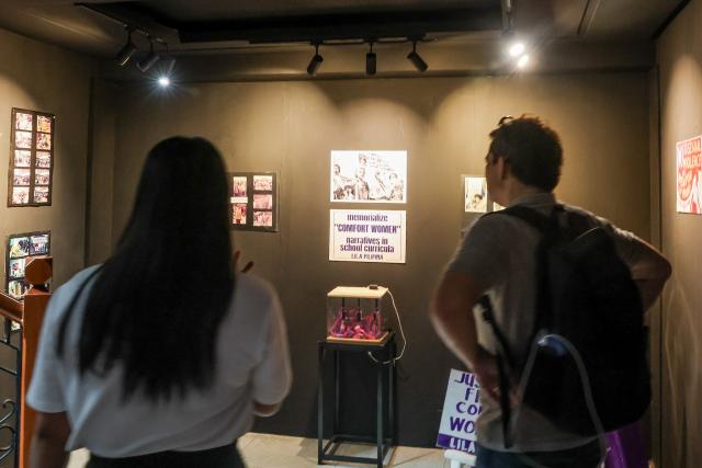 (261005) -- MANILA, Oct. 5, 2026 (Xinhua) -- People visit the exhibition "Courage in Chaos: Narratives of Women and War" in Manila, the Philippines, Oct. 5, 2026. TO GO WITH "Feature: Justice for 'comfort women' -- Philippine exhibition calls for acknowledging wartime atrocities" (Xinhua/Rouelle Umali)