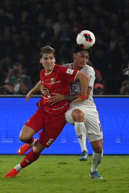 (261005) -- JAKARTA, Oct. 5, 2026 (Xinhua) -- Luke Vickery (L) of Indonesia vies with Nicholas Mickelson of Thailand during the FIFA ASEAN Cup 2026 Division 1 Final Match between Indonesia and Thailand at Gelora Bung Karno Stadium in Jakarta, Indonesia, Oct. 5, 2026. (Xinhua/Agung Kuncahya B.)