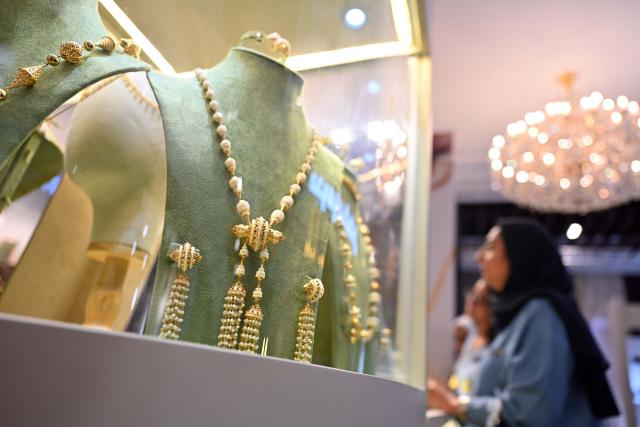 (261005) -- HAWALLI GOVERNORATE, Oct. 5, 2026 (Xinhua) -- Visitors view jewelry on display at the Thameen Expo in Hawalli Governorate, Kuwait, Oct. 5, 2026. The Thameen Expo, featuring jewelry and luxury products, opened Monday at the Kuwait International Fairground in Hawalli Governorate, Kuwait. The exhibition will run through Oct. 10. (Photo by Asad/Xinhua)