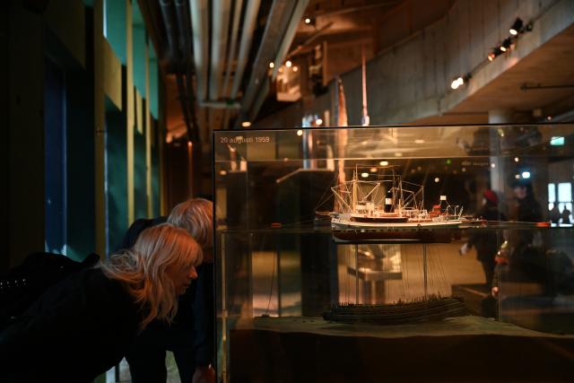 (261006) -- STOCKHOLM, Oct. 6, 2026 (Xinhua) -- Visitors view a model in the exhibition area illustrating the salvage of the warship Vasa at the Vasa Museum in Stockholm, Sweden, on Oct. 5, 2026. The Vasa Museum in Stockholm, Sweden, features the 17th-century warship Vasa as its centerpiece. Through the ship, artifacts and themed exhibitions, the museum tells the story of the vessel's construction, sinking and salvage. The Vasa sank on its maiden voyage in 1628 and was salvaged more than 300 years later. It is one of the best-preserved 17th-century ships in the world. (Xinhua/Lyu You)