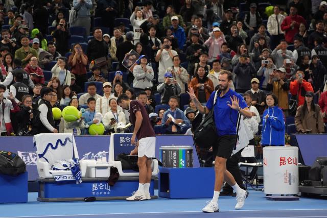 (261006) -- BEIJING, Oct. 6, 2026 (Xinhua) -- Daniil Medvedev (R) leaves the court after the men's singles semifinal match between Daniil Medvedev of Russia and Novak Djokovic of Serbia at 2026 China Open tennis tournament in Beijing, China, Oct. 5, 2026. (Xinhua/Xie Han)
