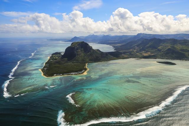 (261006) -- BEIJING, Oct. 6, 2026 (Xinhua) -- An aerial photo taken on Oct. 2, 2026 shows a view of Le Morne Cultural Landscape in Black River District, Mauritius. Le Morne Cultural Landscape, a rugged mountain that juts into the Indian Ocean in the southwest of Mauritius, was inscribed on the UNESCO World Heritage List in 2008. (Xinhua/Chen Wei)