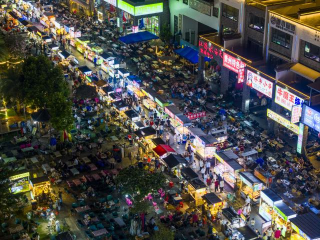 (261006) -- BEIJING, Oct. 6, 2026 (Xinhua) -- An aerial drone photo taken on Oct. 2, 2026 shows people visiting a night market in Wuzhou, south China's Guangxi Zhuang Autonomous Region. During the National Day holiday, night tours were launched across China to create diversified consumption scenes. (Photo by He Huawen/Xinhua)