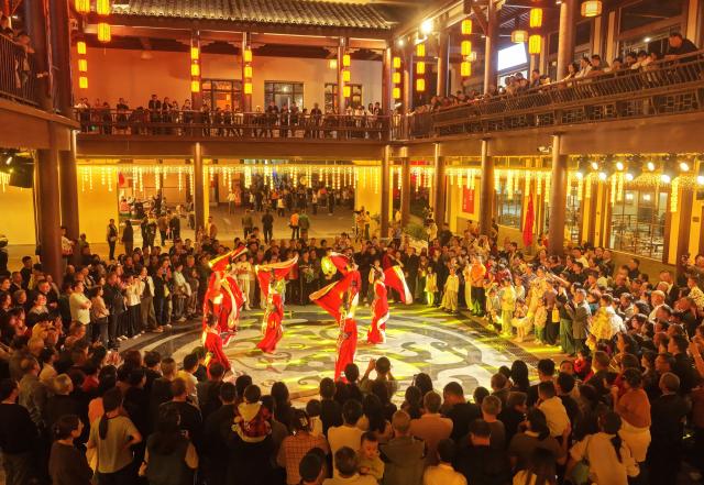 (261006) -- BEIJING, Oct. 6, 2026 (Xinhua) -- A drone photo taken on Oct. 5, 2026 shows people watching a performance at a scenic spot in Zigui County, central China's Hubei Province. During the National Day holiday, night tours were launched across China to create diversified consumption scenes. (Photo by Wang Gang/Xinhua)