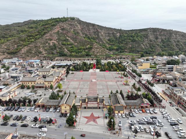 (261006) -- DANGCHANG, Oct. 6, 2026 (Xinhua) -- An aerial drone photo taken on Oct. 4, 2026 shows a memorial hall marking the Red Army's Long March at Hadapu Town in Dangchang County, Longnan City of northwest China's Gansu Province. Hadapu Town was an important stop on the Red Army's Long March. Integrating revolutionary history tourism resources with ancient-town commerce and characteristic agriculture, the town has advanced cultural heritage conservation, preserved the ancient town, and boosted local people's income. (Photo by Liu Hui/Xinhua)