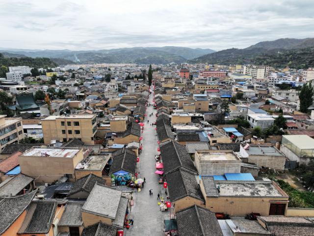(261006) -- DANGCHANG, Oct. 6, 2026 (Xinhua) -- An aerial drone photo taken on Oct. 4, 2026 shows a street named after the Red Army at Hadapu Town in Dangchang County, Longnan City of northwest China's Gansu Province. Hadapu Town was an important stop on the Red Army's Long March. Integrating revolutionary history tourism resources with ancient-town commerce and characteristic agriculture, the town has advanced cultural heritage conservation, preserved the ancient town, and boosted local people's income. (Photo by Liu Hui/Xinhua)