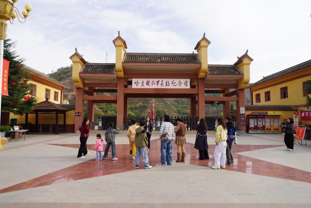 (261006) -- DANGCHANG, Oct. 6, 2026 (Xinhua) -- People visit a memorial hall marking the Red Army's Long March at Hadapu Town in Dangchang County, Longnan City of northwest China's Gansu Province, Oct. 5, 2026. Hadapu Town was an important stop on the Red Army's Long March. Integrating revolutionary history tourism resources with ancient-town commerce and characteristic agriculture, the town has advanced cultural heritage conservation, preserved the ancient town, and boosted local people's income. (Photo by Liu Hui/Xinhua)