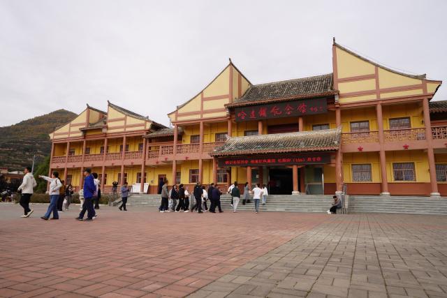 (261006) -- DANGCHANG, Oct. 6, 2026 (Xinhua) -- People visit a memorial hall marking the Red Army's Long March at Hadapu Town in Dangchang County, Longnan City of northwest China's Gansu Province, Oct. 4, 2026. Hadapu Town was an important stop on the Red Army's Long March. Integrating revolutionary history tourism resources with ancient-town commerce and characteristic agriculture, the town has advanced cultural heritage conservation, preserved the ancient town, and boosted local people's income. (Photo by Liu Hui/Xinhua)