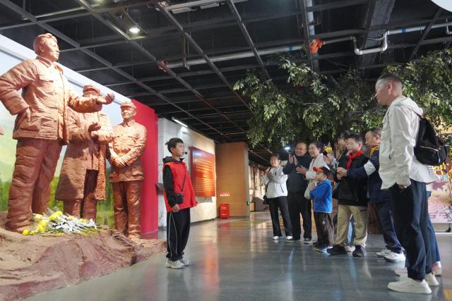 (261006) -- DANGCHANG, Oct. 6, 2026 (Xinhua) -- People visit a memorial hall marking the Red Army's Long March at Hadapu Town in Dangchang County, Longnan City of northwest China's Gansu Province, Oct. 4, 2026. Hadapu Town was an important stop on the Red Army's Long March. Integrating revolutionary history tourism resources with ancient-town commerce and characteristic agriculture, the town has advanced cultural heritage conservation, preserved the ancient town, and boosted local people's income. (Photo by Liu Hui/Xinhua)