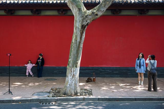(261006) -- HANGZHOU(ZHEJIANG), Oct. 6, 2026 (Xinhua) -- People pose for photos outside the Southern Song Dynasty Deshou Palace Ruins Museum in Hangzhou, east China's Zhejiang Province, Oct. 6, 2026. During the National Day holiday, tourists across the country visited the museum to appreciate cultural attractions. (Xinhua/Jiang Han)