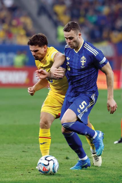 (261006) -- BUCHAREST, Oct. 6, 2026 (Xinhua) -- Romania's Razvan Marin (L) vies with Sweden's Gabriel Gudmundsson during the UEFA Nations League 2026/27 League B Group B4 match between Romania and Sweden in Bucharest, Romania, Oct. 5, 2026. (Photo by Cristian Cristel/Xinhua)