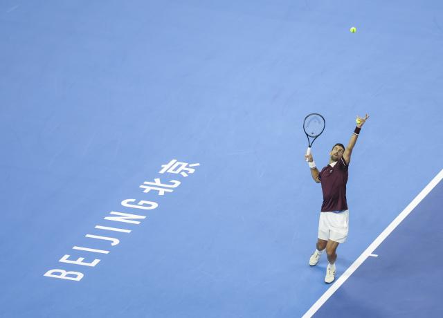 (261006) -- BEIJING, Oct. 6, 2026 (Xinhua) -- Novak Djokovic of Serbia serves during the men's singles final match against Alex de Minaur of Australia at 2026 China Open tennis tournament in Beijing, China, Oct. 6, 2026. (Xinhua/Bai Xuefei)