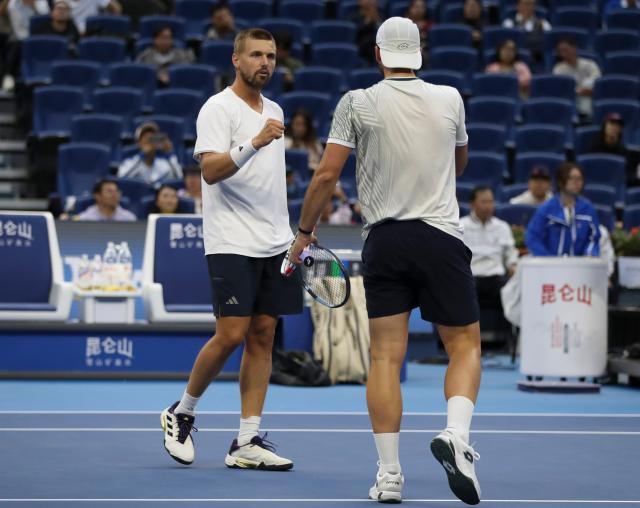 (261006) -- BEIJING, Oct. 6, 2026 (Xinhua) -- Julian Cash (L)/Lloyd Glasspool of Britain celebrate after winning the men's doubles final match against Sander Arends/David Pel of the Netherlands at 2026 China Open tennis tournament in Beijing, China, Oct. 6, 2026. (Photo by Ma Zihan/Xinhua)
