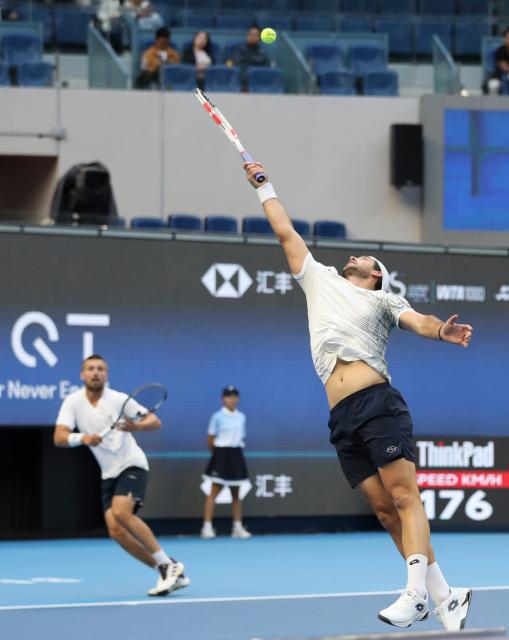 (261006) -- BEIJING, Oct. 6, 2026 (Xinhua) -- Julian Cash (R)/Lloyd Glasspool of Britain compete during the men's doubles final match against Sander Arends/David Pel of the Netherlands at 2026 China Open tennis tournament in Beijing, China, Oct. 6, 2026. (Photo by Ma Zihan/Xinhua)