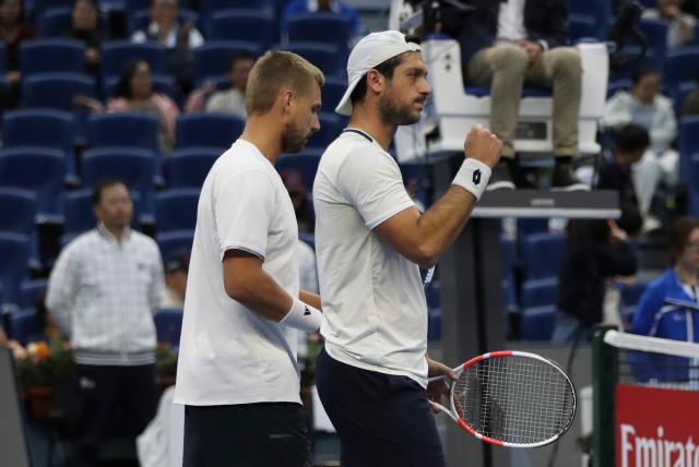 (261006) -- BEIJING, Oct. 6, 2026 (Xinhua) -- Julian Cash (R)/Lloyd Glasspool of Britain celebrate after winning the men's doubles final match against Sander Arends/David Pel of the Netherlands at 2026 China Open tennis tournament in Beijing, China, Oct. 6, 2026. (Photo by Ma Zihan/Xinhua)