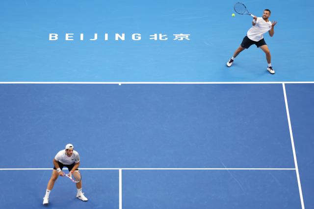 (261006) -- BEIJING, Oct. 6, 2026 (Xinhua) -- Julian Cash/Lloyd Glasspool (R) of Britain compete during the men's doubles final match against Sander Arends/David Pel of the Netherlands at 2026 China Open tennis tournament in Beijing, China, Oct. 6, 2026. (Xinhua/Zhang Chenlin)