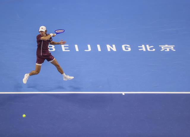 (261006) -- BEIJING, Oct. 6, 2026 (Xinhua) -- Alex de Minaur of Australia hits a return during the men's singles final match against Novak Djokovic of Serbia at 2026 China Open tennis tournament in Beijing, China, Oct. 6, 2026. (Photo by Ma Zihan/Xinhua)