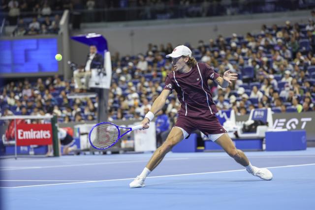 (261006) -- BEIJING, Oct. 6, 2026 (Xinhua) -- Alex de Minaur of Australia hits a return during the men's singles final match against Novak Djokovic of Serbia at 2026 China Open tennis tournament in Beijing, China, Oct. 6, 2026. (Xinhua/Bai Xuefei)