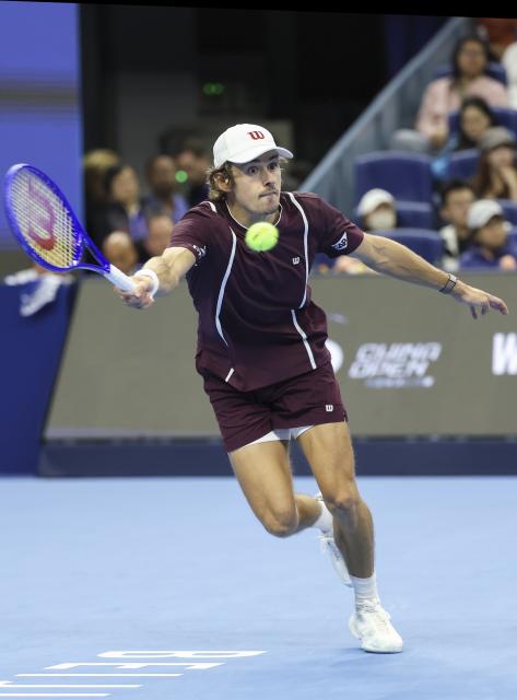 (261006) -- BEIJING, Oct. 6, 2026 (Xinhua) -- Alex de Minaur of Australia hits a return during the men's singles final match against Novak Djokovic of Serbia at 2026 China Open tennis tournament in Beijing, China, Oct. 6, 2026. (Xinhua/Bai Xuefei)