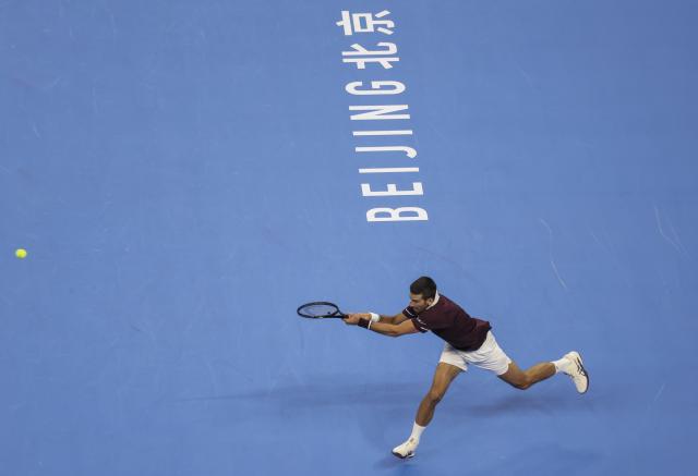(261006) -- BEIJING, Oct. 6, 2026 (Xinhua) -- Novak Djokovic of Serbia hits a return during the men's singles final match against Alex de Minaur of Australia at 2026 China Open tennis tournament in Beijing, China, Oct. 6, 2026. (Xinhua/Bai Xuefei)