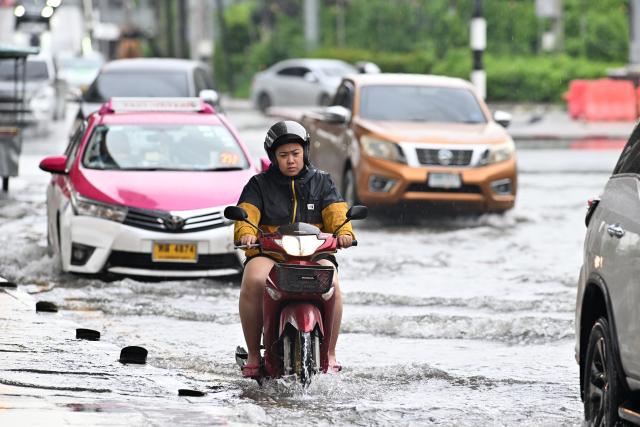 (261006) -- BANGKOK, Oct. 6, 2026 (Xinhua) -- A local resident rides a motorcycle through floodwater in Bangkok, Thailand on Oct. 6, 2026. Floods across Thailand have killed 31 people and affected about 4.14 million others since Sept. 16, authorities said on Monday. (Xinhua/Rachen Sageamsak)