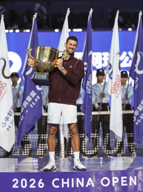 (261006) -- BEIJING, Oct. 6, 2026 (Xinhua) -- Novak Djokovic of Serbia poses with the champion trophy during the awarding ceremony for the men's singles final at 2026 China Open tennis tournament in Beijing, China, Oct. 6, 2026. (Xinhua/Bai Xuefei)